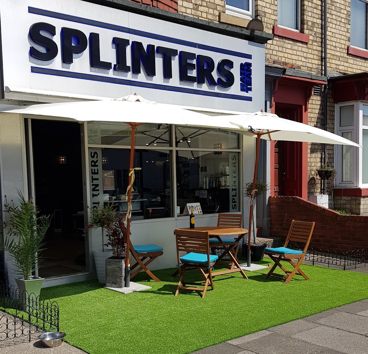 The Splinters Hair Team shopfront on Whitley Road, with parasols and a little garden out front