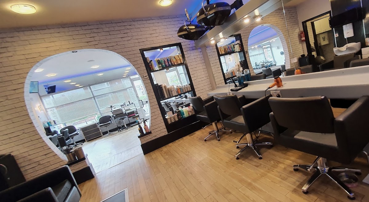 Inside the Splinters salon, with white-brick walls, big mirrors and styling chairs